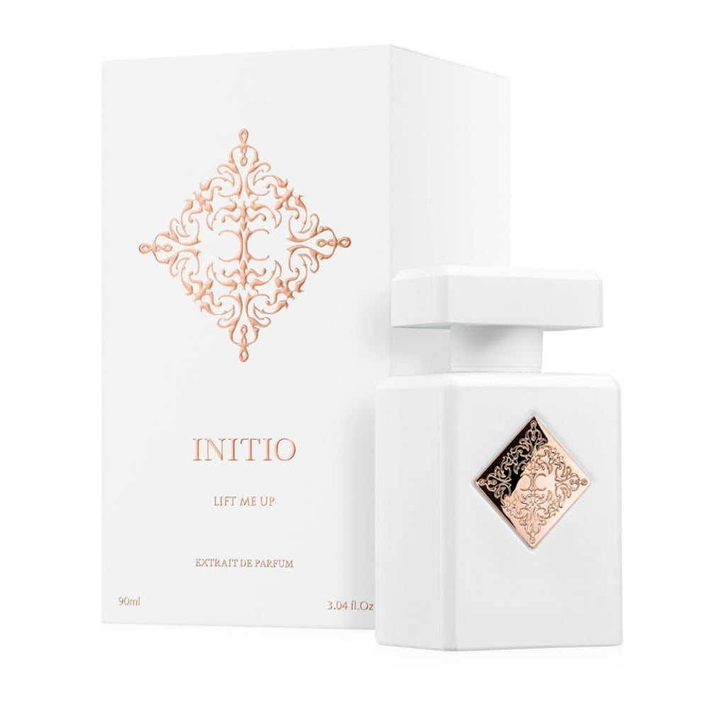 White Initio 'Lift Me Up' perfume bottle with a matching white box, both featuring a rose gold ornate diamond design.