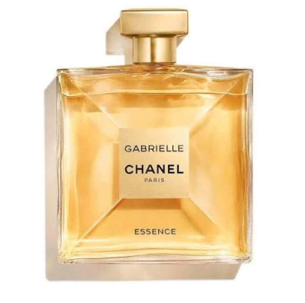 Chanel Gabrielle Essence perfume bottle with a gold cap and golden-amber liquid, shown on a white background with a soft shadow.