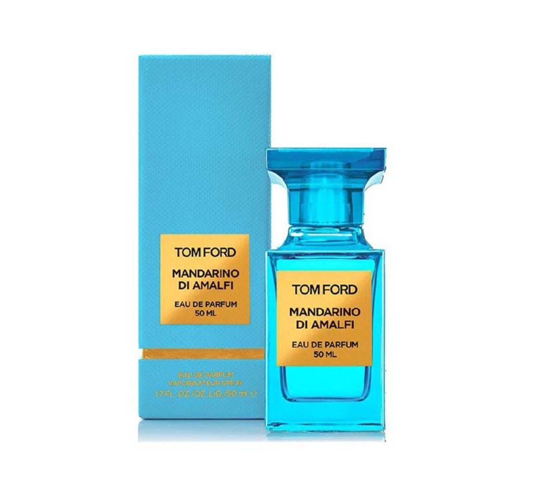 TOM FORD Mandarino Di Amalfi bottle in vibrant blue glass next to its matching blue box with gold labels, on a white background.